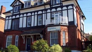 A traditional Tudor-style building with a prominent balcony and a sign reading "Ingleside House". - Ingledene Guest House  (Bournemouth)