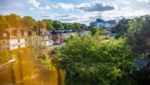 A residential area with houses and a modern building in the background. - Ingledene Guest House  (Bournemouth)