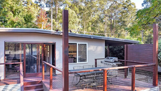A modern house with a deck, a barbecue area, and a large window overlooking a garden. - Ren Basera - Minutes from the base of Mt Buller (Sawmill Settlement)