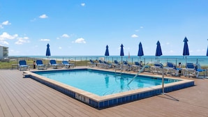 A pool area with lounge chairs and umbrellas, a clear sky, and a view of the ocean. - Lost Key Golf & Beach Club Townhome -Make Waves ~  NO HASSLE CHECK OUT (Perdido Key)