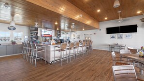 A spacious bar area with high wooden ceilings and a variety of seating options. - Lost Key Golf & Beach Club Townhome -Make Waves ~  NO HASSLE CHECK OUT (Perdido Key)