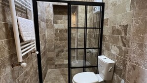 A bathroom with a shower enclosure, a toilet, and a towel rack. - Gökhan Bey Konağı  (Gaziantep)