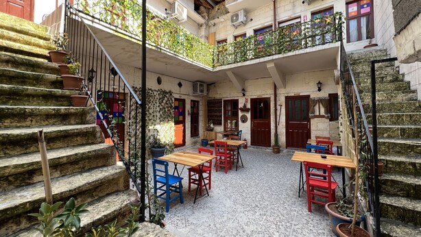 A courtyard with stone steps, outdoor seating, and potted plants. - Gökhan Bey Konağı  (Gaziantep)