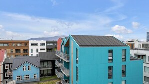 A modern residential building with a flat roof and multiple balconies. - Svala Downtown Studio (Reykjavík)