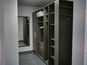 Ample storage and a spacious mirror make this walk-in closet a haven for organization.