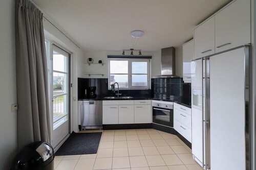 Luxury 4-person beach villa with hot tub, whirlpool, and cozy fireplace at Beach Resort Makkum, right on the beach of the IJsselmeer.