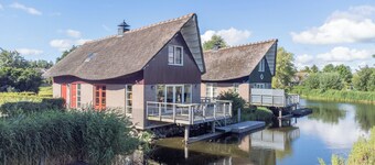Detached 8-person fisherman's villa with a patio above the water and a private jetty at Beach Resort Makkum on the IJsselmeer.