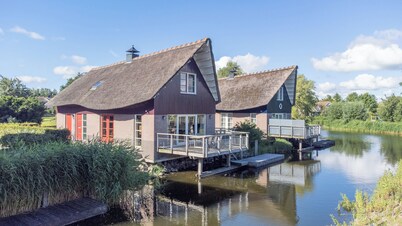 Detached 8-person fisherman's villa with a patio above the water and a private jetty at Beach Resort Makkum on the IJsselmeer.