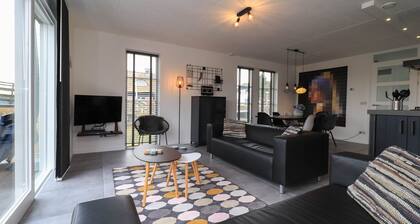 Luxury 8-person fishing villa with a sauna, patio above the water, and private jetty at Beach Resort Makkum on the IJsselmeer.