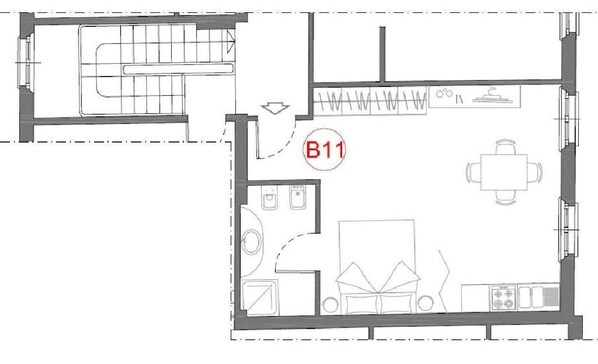 A floor plan of a hotel room with a kitchenette, a dining area, a bathroom, and a living space. - 1-Bedroom Apartment in Modena (Modena)