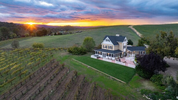 A large house with a spacious patio and vineyard in the background. - Hot Tub + Fire Pit | Vineyard Near Templeton + Paso | Vineyard Retreat (Templeton)
