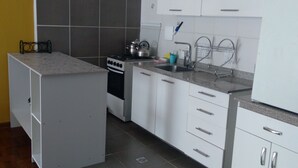 A kitchen with white cabinets, a stove, and a sink. - La Paz, Bolivia; Wonder City, Nice Apartment, Central and safe (La Paz)