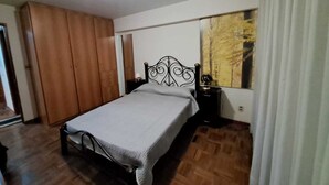 A bedroom with a bed, wooden wardrobe, and a nightstand. - La Paz, Bolivia; Wonder City, Nice Apartment, Central and safe (La Paz)