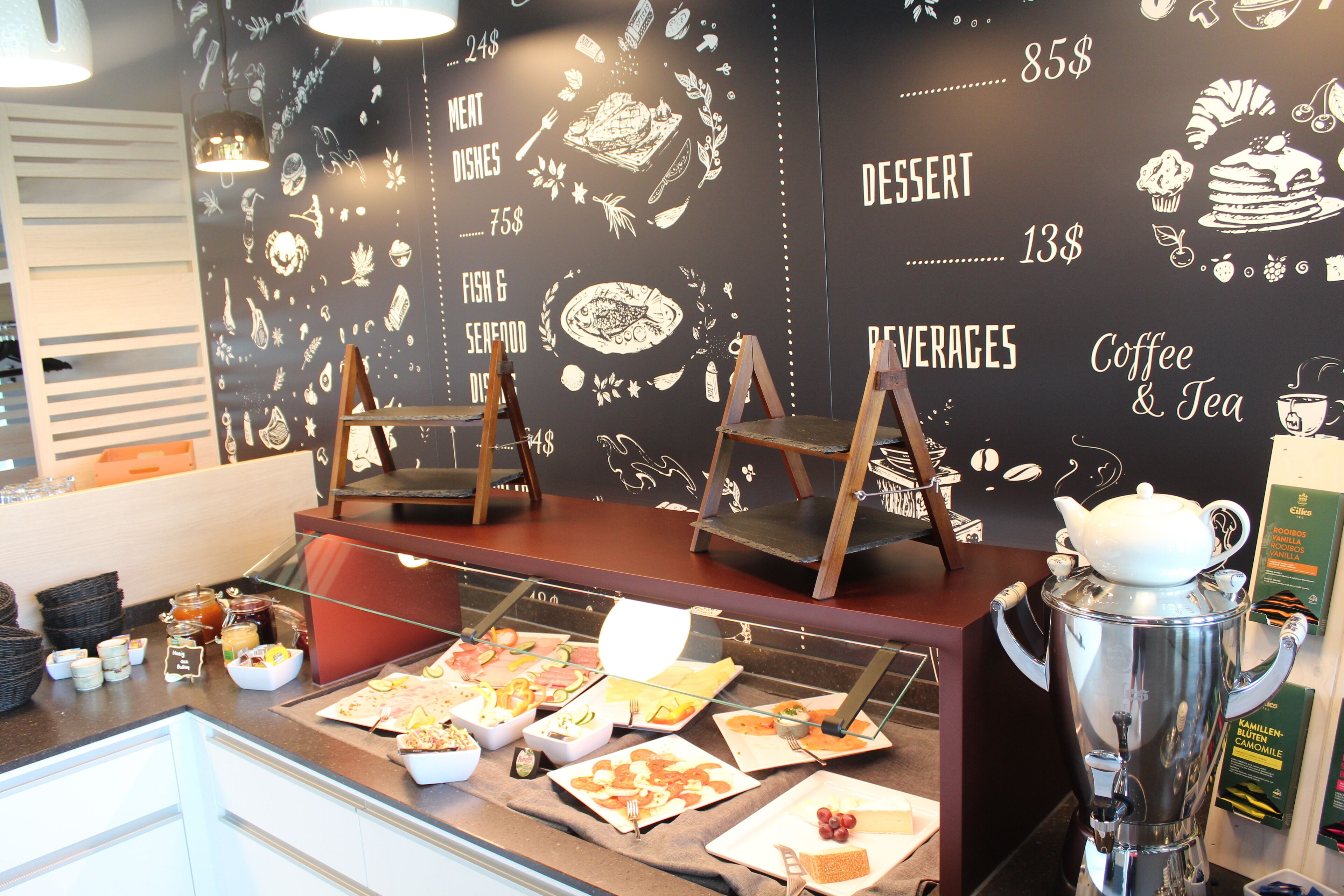 A buffet area with various food options and a coffee station.