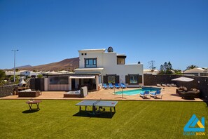 Relax by the pool surrounded by lounge chairs and enjoy the scenic views of the surrounding mountains.