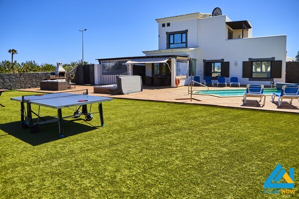 Enjoy a relaxing stay in our spacious outdoor area with a lawn, pool, and sun terrace featuring comfortable seating and a ping pong table.