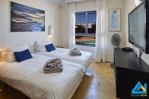 Enjoy a beach view from the comfort of this stylish room, featuring two single beds and a flat-screen TV.