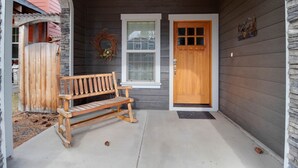 A wooden bench outside a house with a door and window. - The Quails Nest - charming 3 bedroom 2.5 bath with fireplace in Sisters Oregon (Sisters)