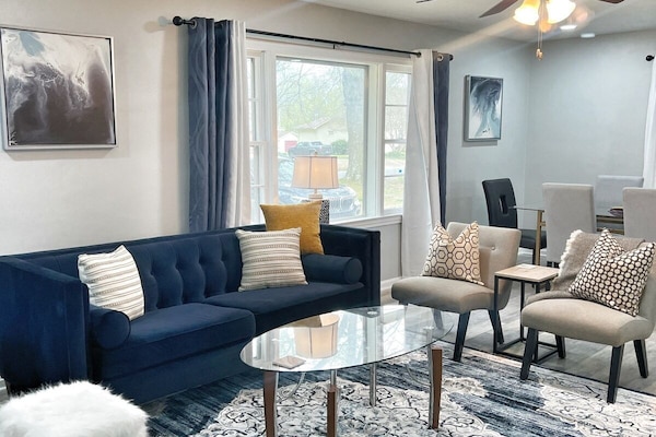 Bright, open living area with plush seating and smart TV — perfect for relaxing together.