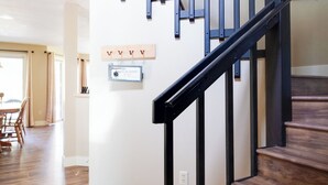 A wooden staircase with black railings leading to an upper floor.