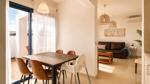 A modern living room with a dining area, a sofa, and a coffee table. - Villa Ancor (Playa Blanca)