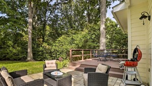 An outdoor patio with wicker furniture and a barbecue grill. - Renovated Raleigh Retreat w/ Patio in North Hills! (Raleigh)