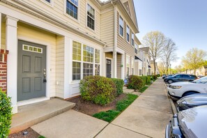 A row of townhouses with front doors, a sidewalk, and parked cars. - Townhome w/ Community Pool: 11 Mi to Dtwn Raleigh! (Raleigh)