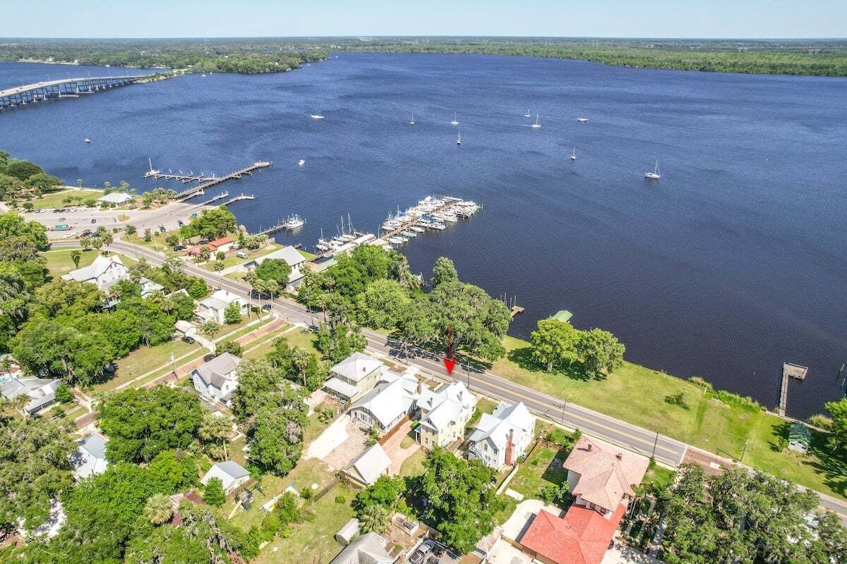 A coastal town with a marina, houses, and a bridge.