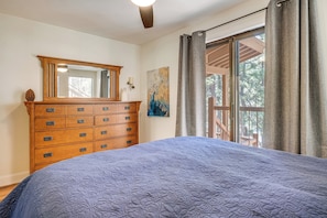 A bedroom with a large bed, a wooden dresser, a mirror, a painting, and a window with curtains. - < 3 Mi to Lake Tahoe: Incline Village Condo! (Incline Village)