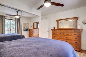 A bedroom with two beds, a wooden dresser, a ceiling fan, and a large mirror. - < 3 Mi to Lake Tahoe: Incline Village Condo! (Incline Village)