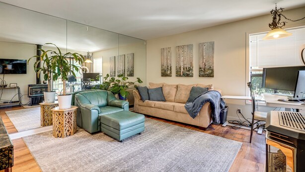 A modern living room with a sofa, a coffee table, a TV, and a fireplace. - < 3 Mi to Lake Tahoe: Incline Village Condo! (Incline Village)