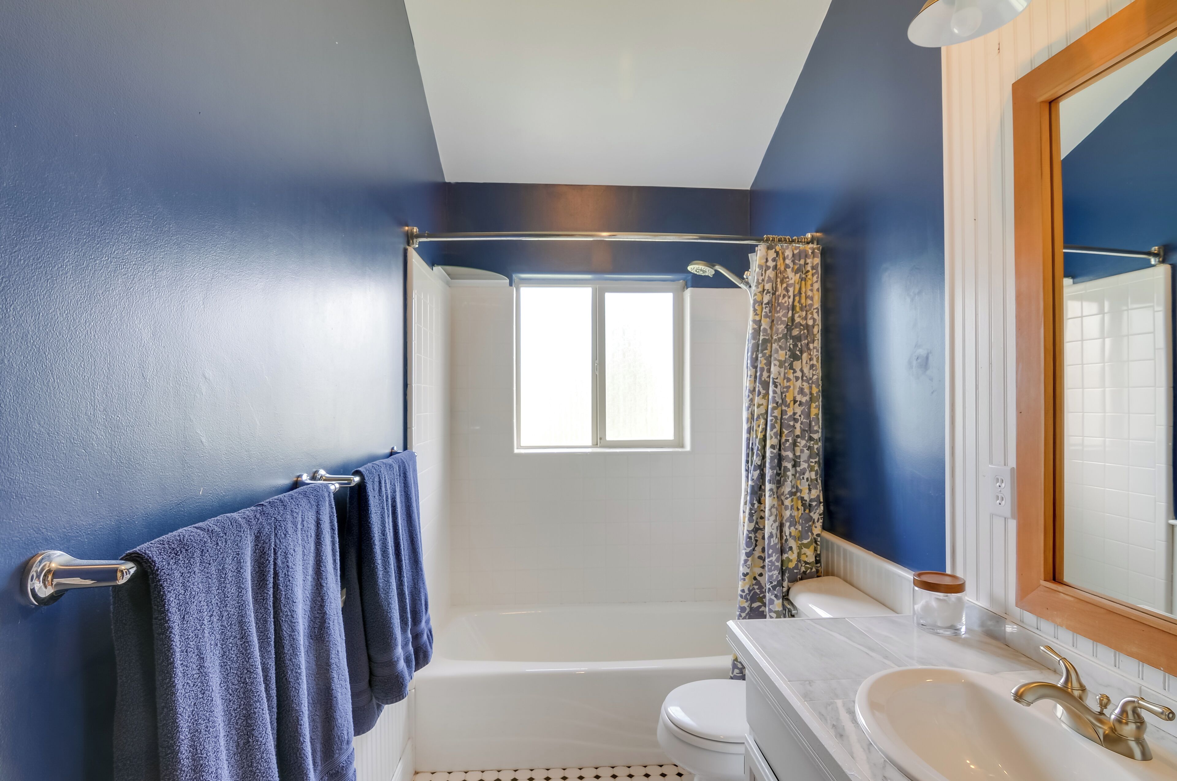 A bathroom with a bathtub, toilet, and sink.