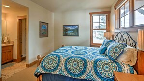 A bedroom with a large bed, a wooden headboard, and a window with a view of trees. - Mtn-view Gem w/ On-site Golf! 3 Mi to Granby Ranch (Granby)