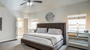 A bedroom with a large bed, a ceiling fan, a dresser, and a window with blinds. - Pet-friendly Tulsa Escape w/ Private Hot Tub! (Tulsa)