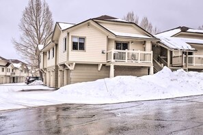 A two-story residential building with a balcony and a garage.