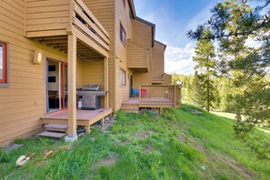 A wooden cabin with a deck, outdoor grill, and a covered porch area. - 4 Mi to Marina: Family Townhome in Silverthorne! (Silverthorne)