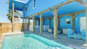 A blue house with a pool, wooden deck, and outdoor seating. - Private Pool & Furnished Deck: Port Aransas Home! (Port Aransas)