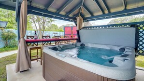 A hot tub under a covered patio with a table and chairs nearby. - San Antonio Retreat w/ Private Hot Tub & Gas Grill (San Antonio)