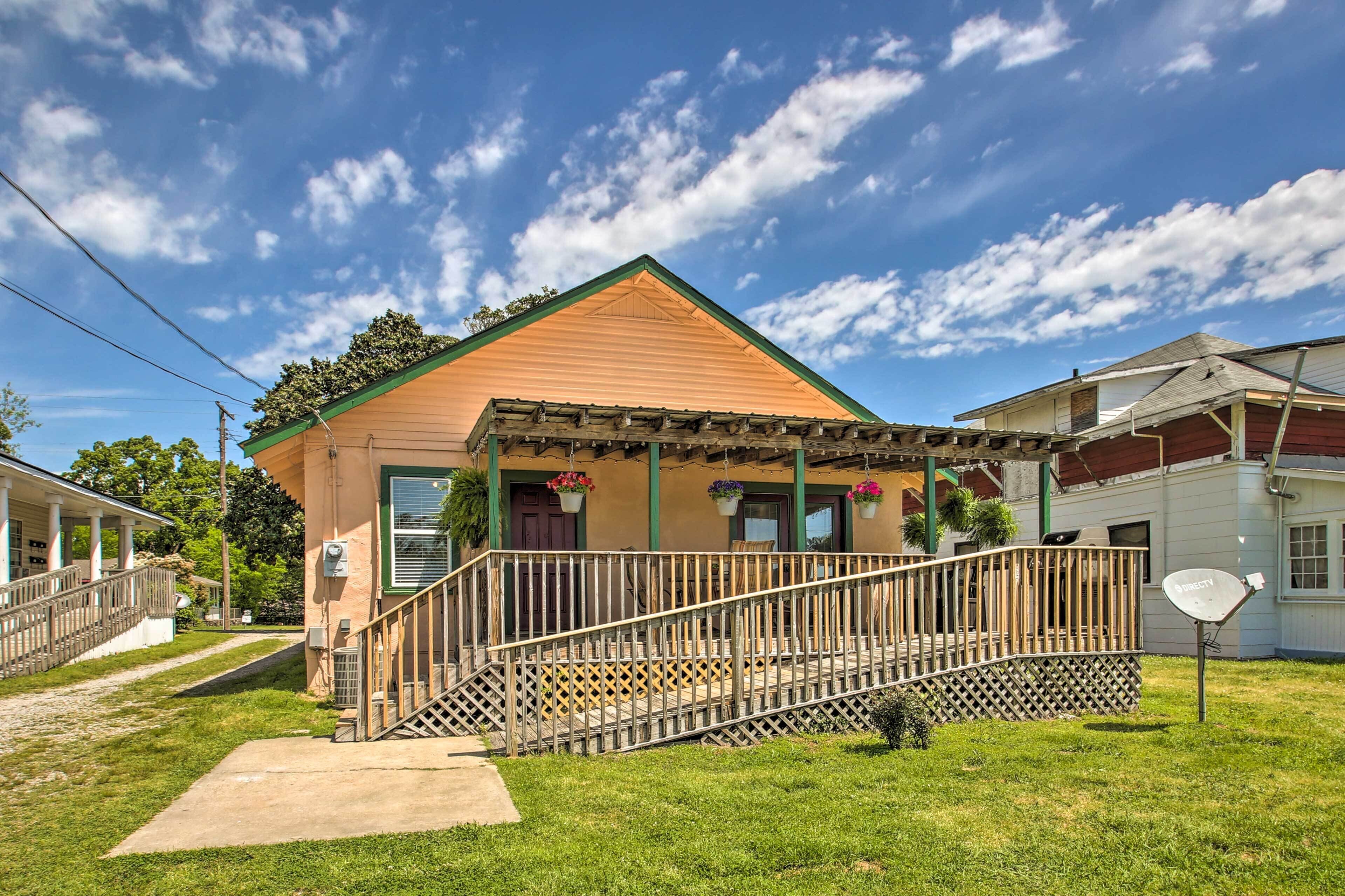 A single-story house with a porch, a small staircase, and a mailbox.