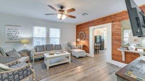 A spacious living room with a ceiling fan, a sofa set, a coffee table, and a television. - 3 Mi to Baylor U: Home w/ Shared Yard (Waco)