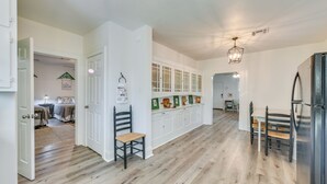 A spacious kitchen with a central island, white cabinetry, and a dining area with a table and chairs. - 3 Mi to Baylor U: Home w/ Shared Yard (Waco)