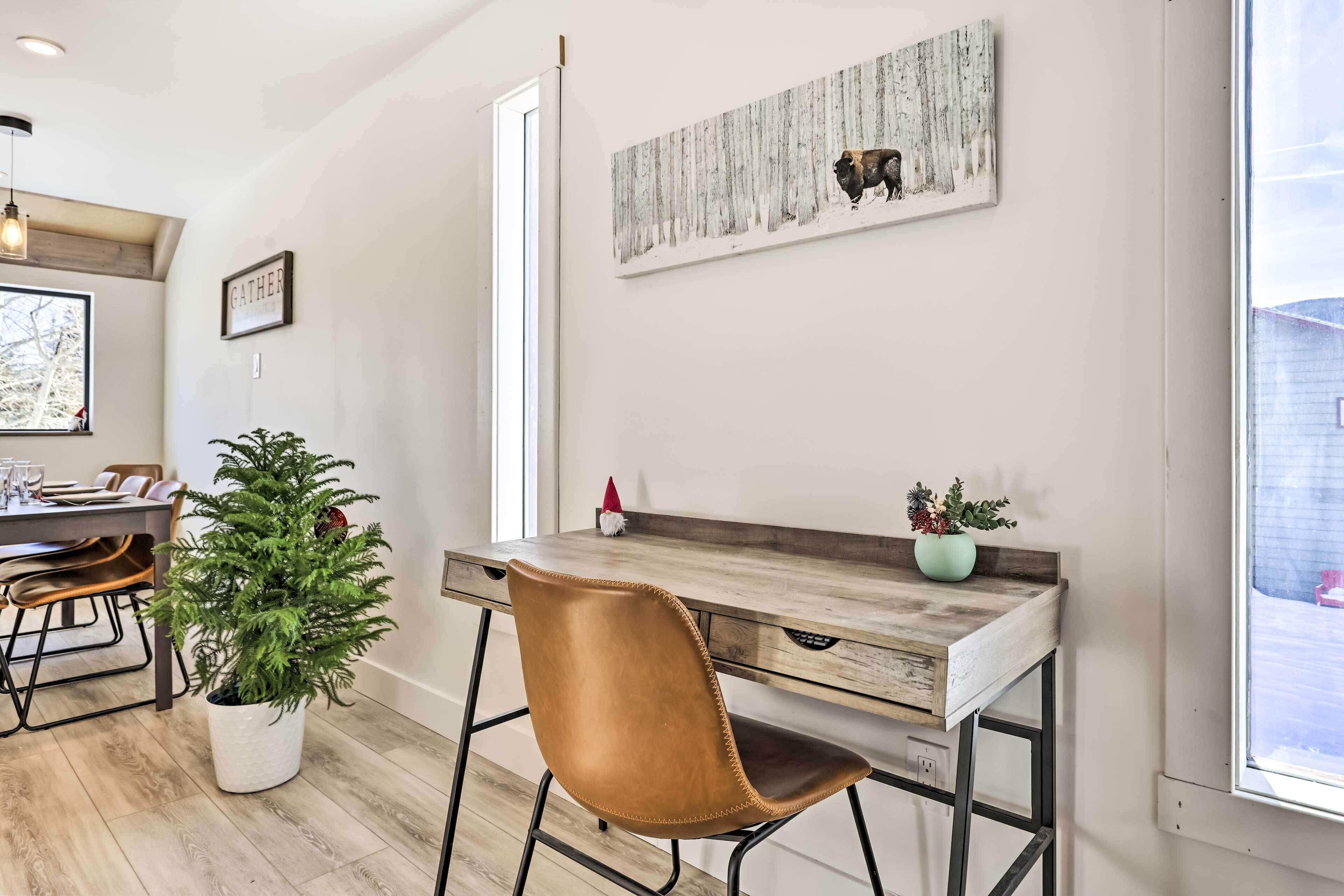 A modern dining area with a wooden table, a brown leather chair, and a potted plant.
