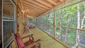 A wooden cabin with large windows, a wooden ceiling, and a cozy seating area. - Kennebec River Cottage; 1/4 Mi to Boat Ramp! (Bath)