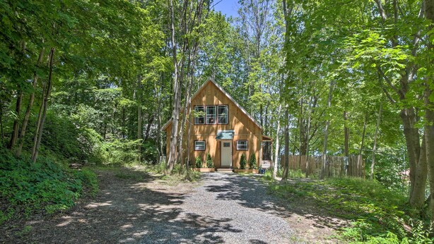 A wooden cabin surrounded by dense forest. - Kennebec River Cottage; 1/4 Mi to Boat Ramp! (Bath)