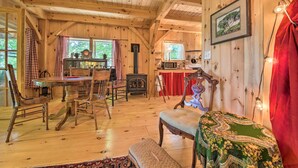 A wooden cabin interior with a dining area, a bench, and a fireplace. - Kennebec River Cottage; 1/4 Mi to Boat Ramp! (Bath)
