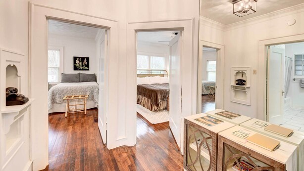 A bedroom with a bed, bedside table, and a mirror. - 2 Mi to Dtwn: Waco Home w/ Shared Yard! (Waco)