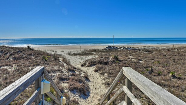 A wooden boardwalk leading to a beach with clear skies. - Emerald Isle Resort-style Condo: Walk to Beaches! (Emerald Isle)