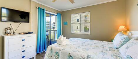 A bedroom with a bed, a ceiling fan, a TV, a dresser, and a window with blinds.