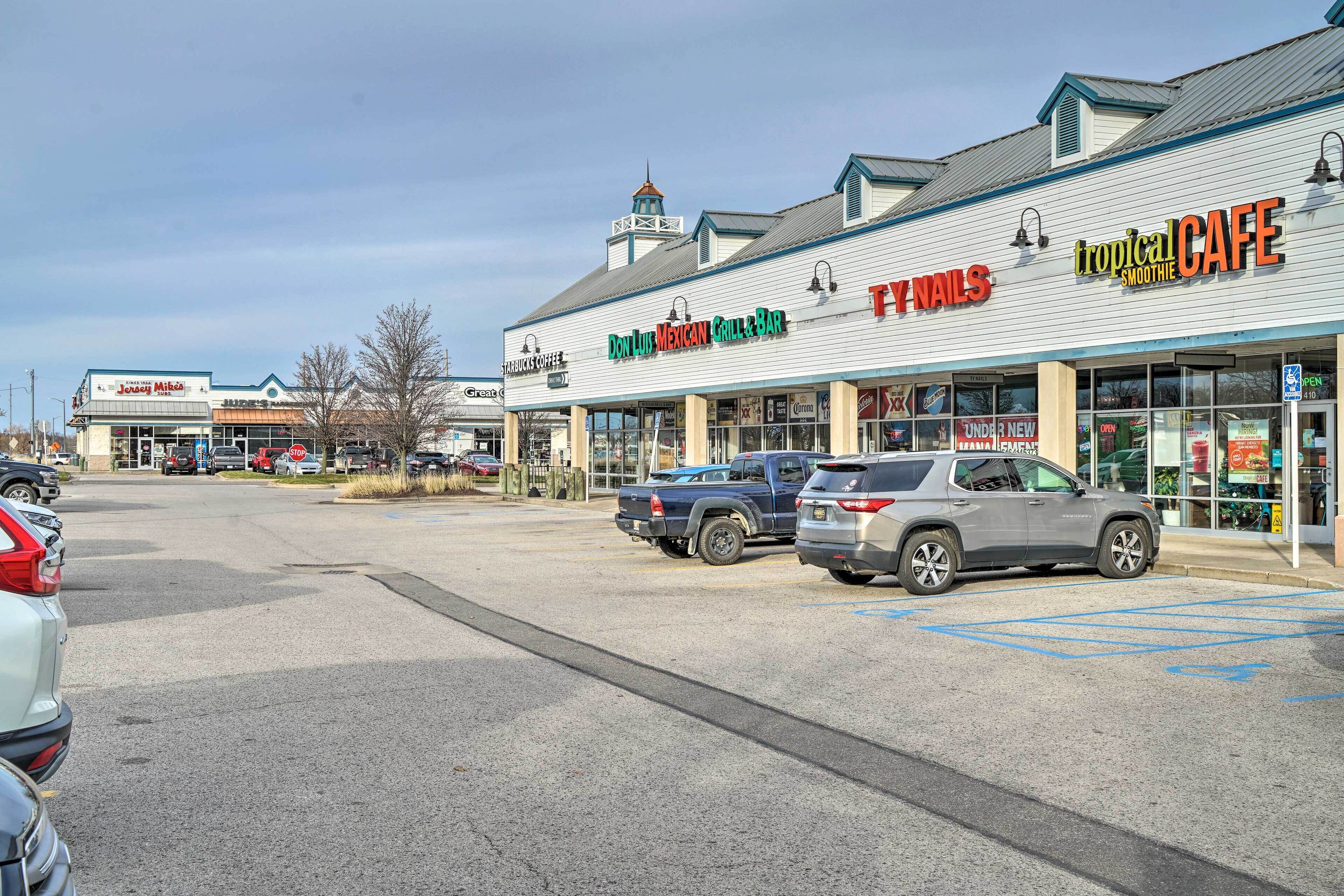 A commercial building with multiple storefronts, including a Mexican Grill and a Tropical Cafe.