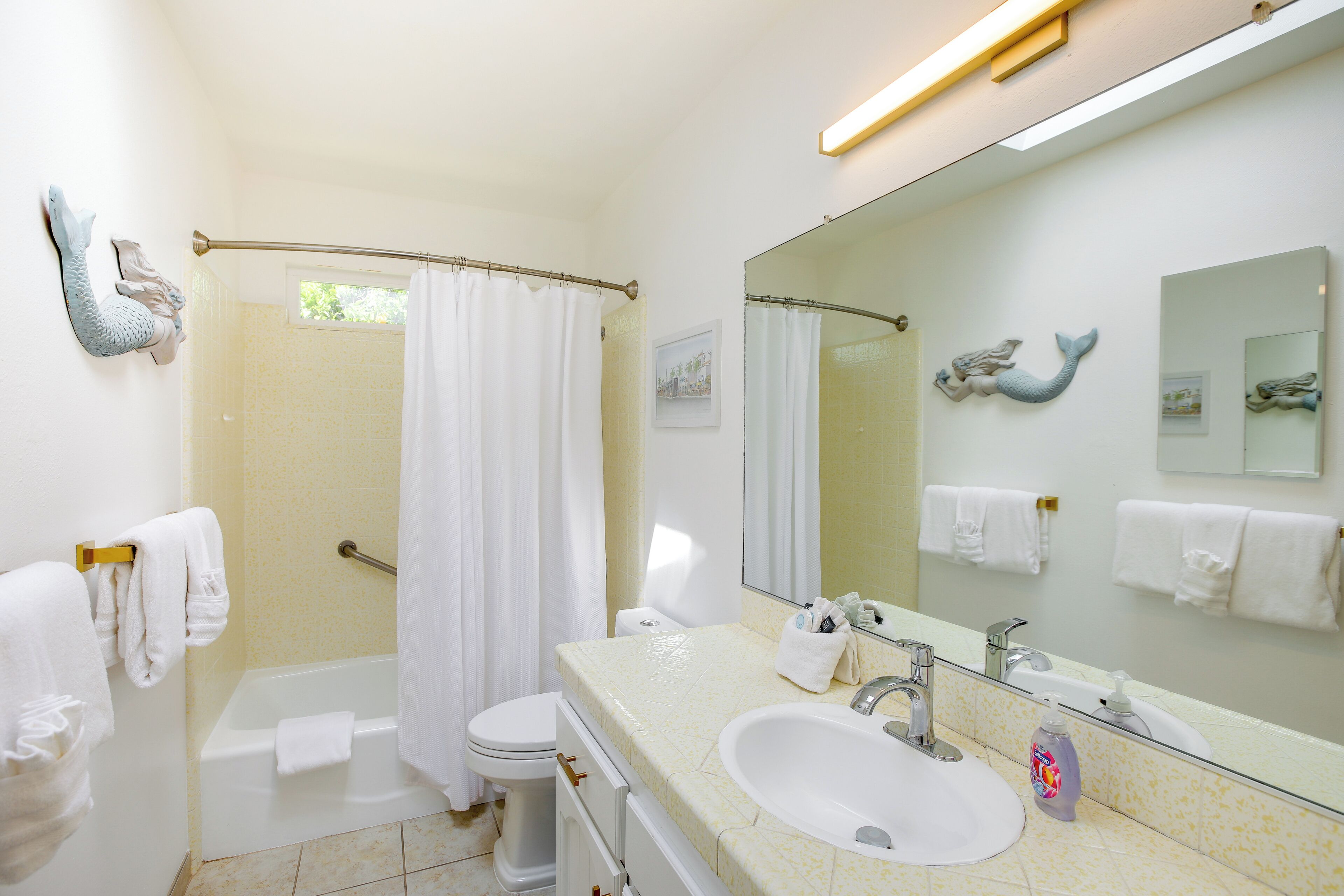A bathroom with a bathtub, toilet, and sink.